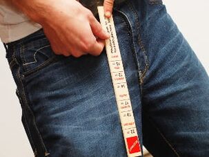 A man measures the length of his penis